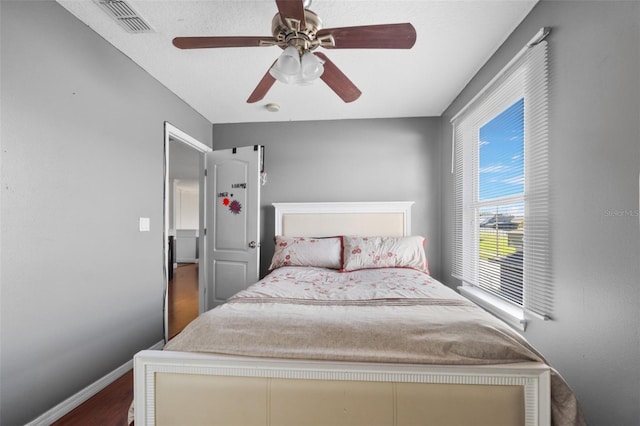 bedroom with ceiling fan and wood-type flooring