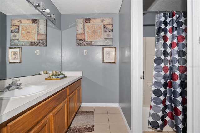 bathroom with a textured ceiling, vanity, shower / bath combo, and tile patterned floors