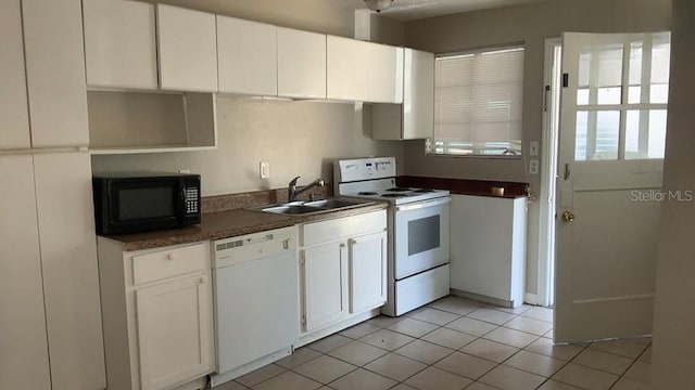 kitchen featuring light tile patterned floors, white appliances, sink, and white cabinetry