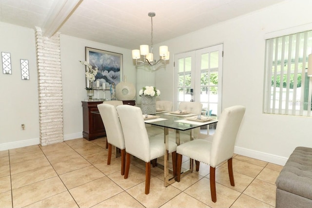 dining room with light tile patterned flooring, a wealth of natural light, and a notable chandelier