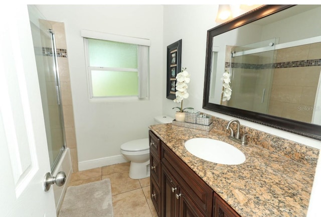 full bathroom featuring tile patterned floors, vanity, shower / bath combination with glass door, and toilet