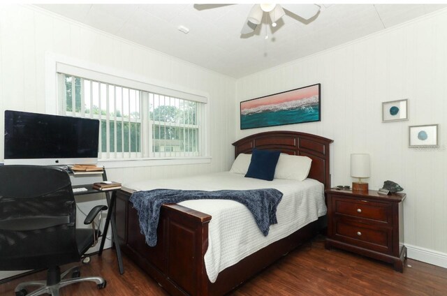 bedroom featuring ceiling fan, crown molding, and dark wood-type flooring