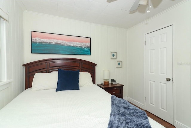 bedroom featuring ceiling fan, crown molding, and wood-type flooring