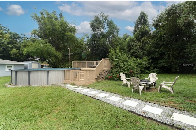 view of yard with a swimming pool side deck