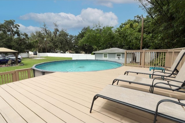 view of swimming pool with a deck and a yard