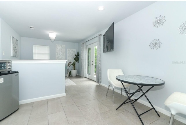 kitchen with refrigerator and light tile patterned floors