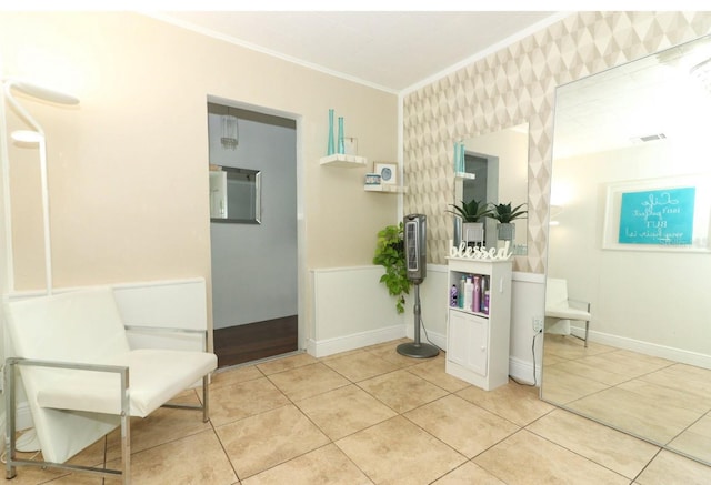 sitting room featuring crown molding and light tile patterned floors