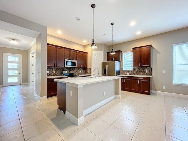 kitchen featuring stainless steel appliances, plenty of natural light, and decorative backsplash