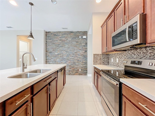 kitchen featuring stainless steel appliances, tasteful backsplash, sink, light tile patterned floors, and hanging light fixtures