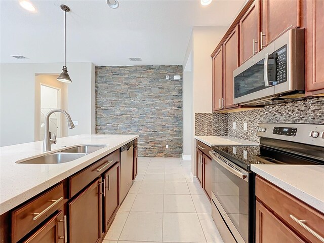 8851 Sperry St, Orlando, FL 32827 - kitchen featuring visible vents, a sink, appliances with stainless steel finishes, light tile patterned floors, and decorative light fixtures