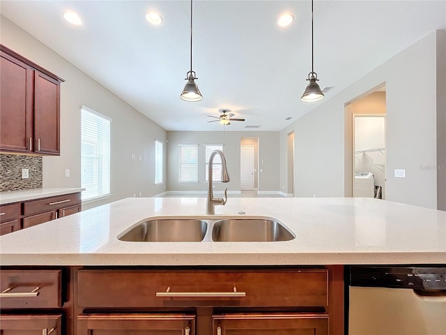 kitchen with sink, light stone counters, stainless steel dishwasher, ceiling fan, and hanging light fixtures