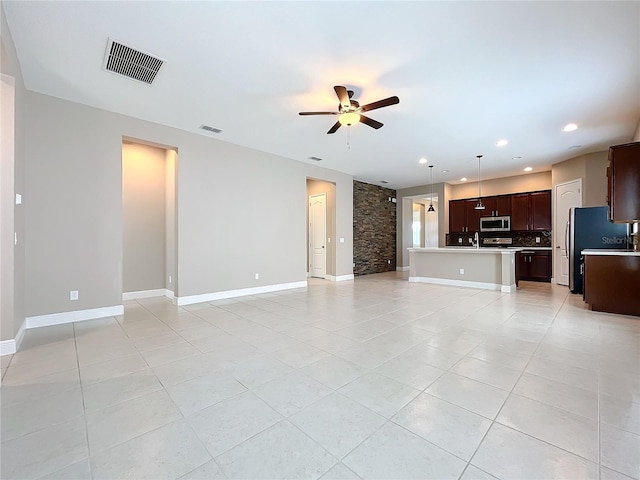 unfurnished living room with ceiling fan and light tile patterned floors