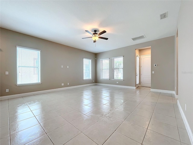 empty room featuring ceiling fan and light tile patterned floors