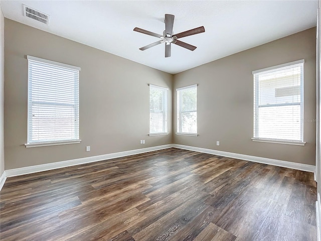 spare room with ceiling fan and dark hardwood / wood-style floors