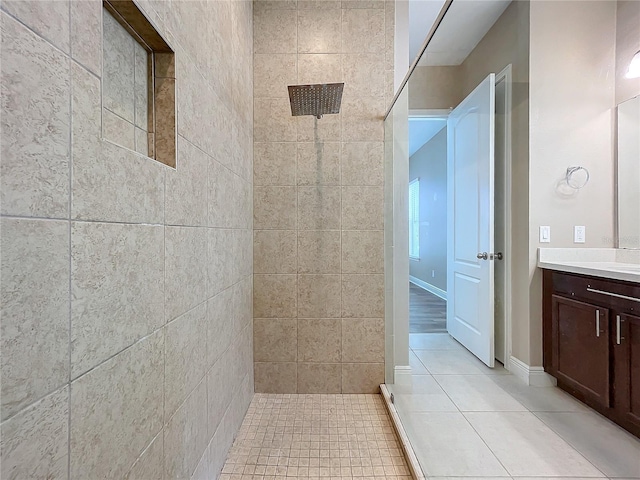 bathroom with tile patterned flooring, tile walls, a shower, and vanity