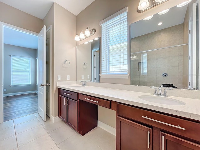 bathroom featuring a tile shower, vanity, and hardwood / wood-style floors