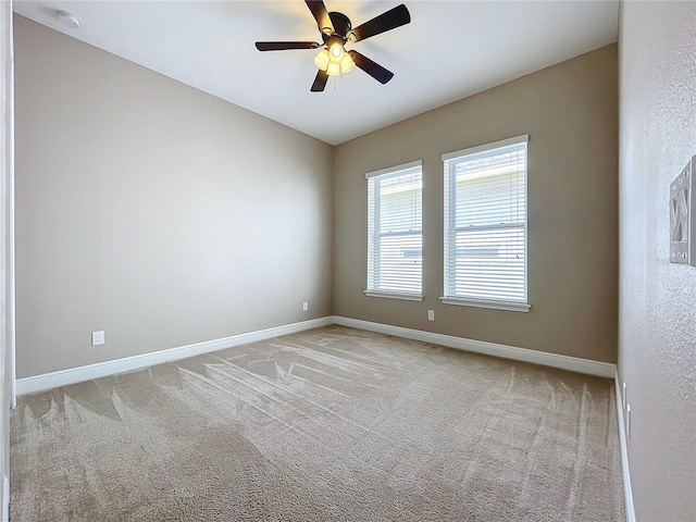 carpeted empty room with ceiling fan