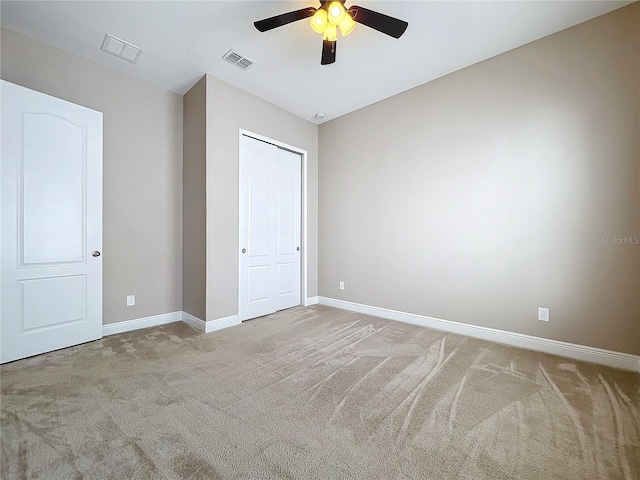 unfurnished bedroom with carpet flooring, ceiling fan, and a closet