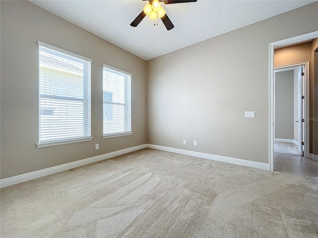 carpeted spare room with ceiling fan