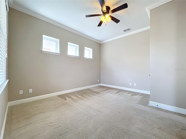 empty room featuring ceiling fan, carpet floors, and ornamental molding