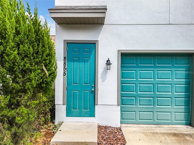 view of exterior entry featuring a garage