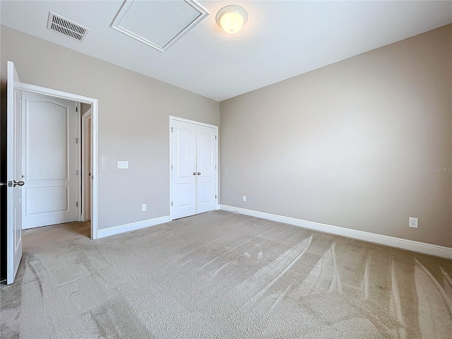 unfurnished bedroom with a closet and light carpet