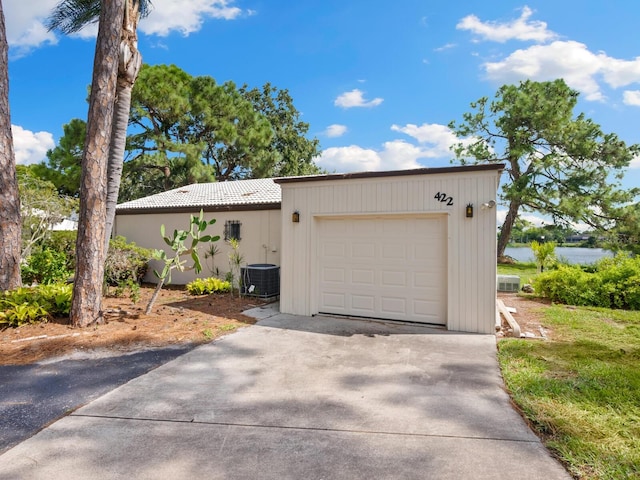 view of front of property featuring a garage and central AC