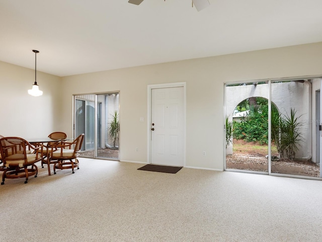 carpeted entrance foyer with ceiling fan