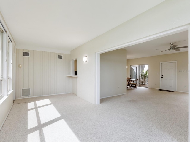 carpeted empty room featuring ceiling fan