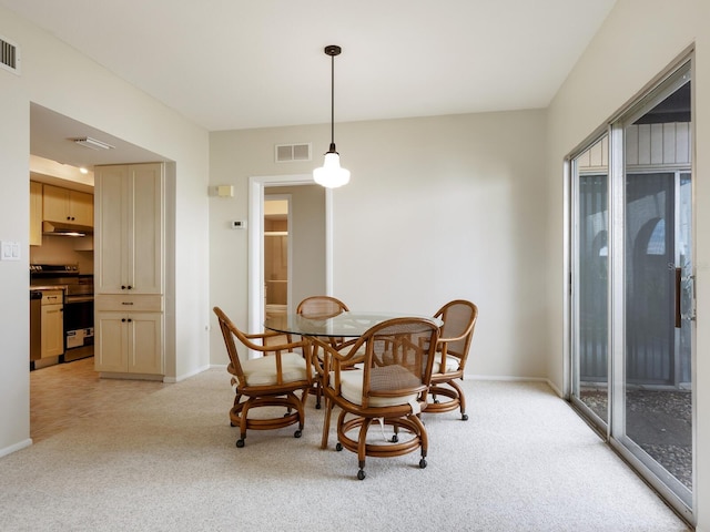 dining area featuring light colored carpet