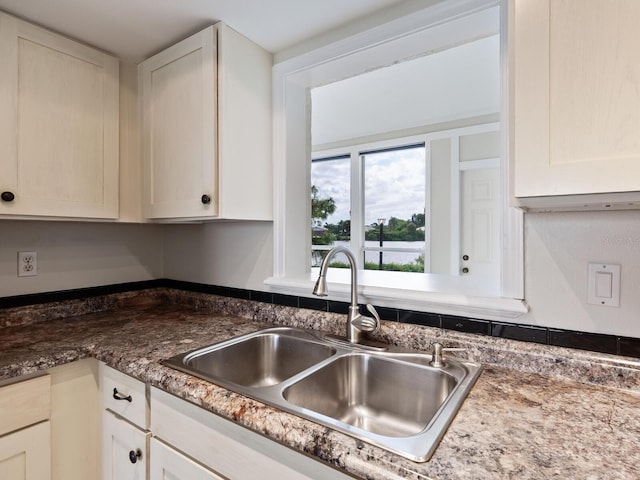 kitchen with dark stone counters and sink