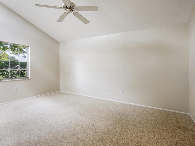 spare room with lofted ceiling, ceiling fan, and carpet flooring