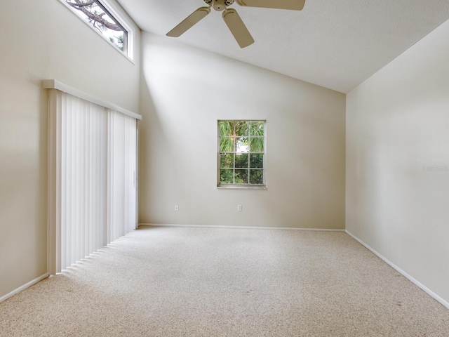 spare room featuring carpet flooring, ceiling fan, and vaulted ceiling