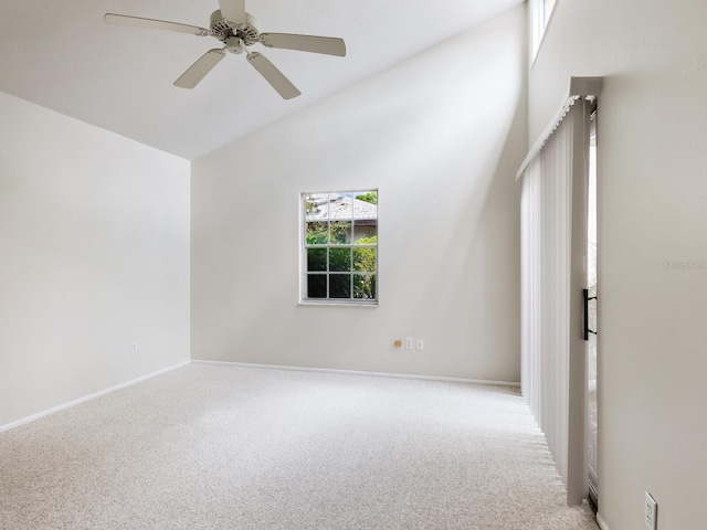 carpeted empty room featuring lofted ceiling and ceiling fan