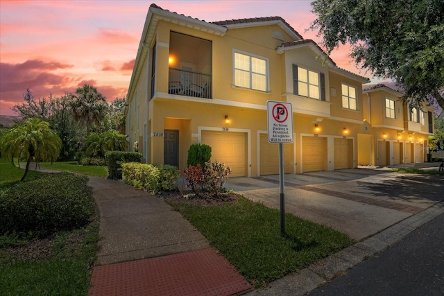 mediterranean / spanish home featuring a balcony and a garage