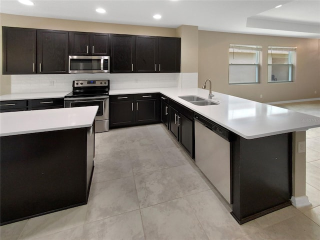 kitchen featuring tasteful backsplash, light tile patterned floors, stainless steel appliances, and sink