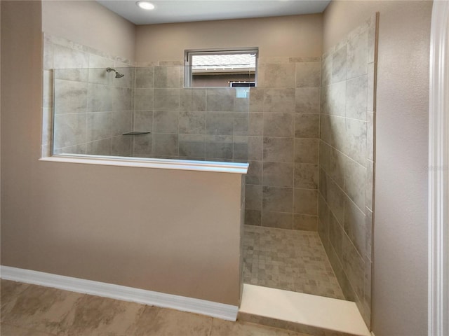 bathroom with tile patterned floors and a tile shower