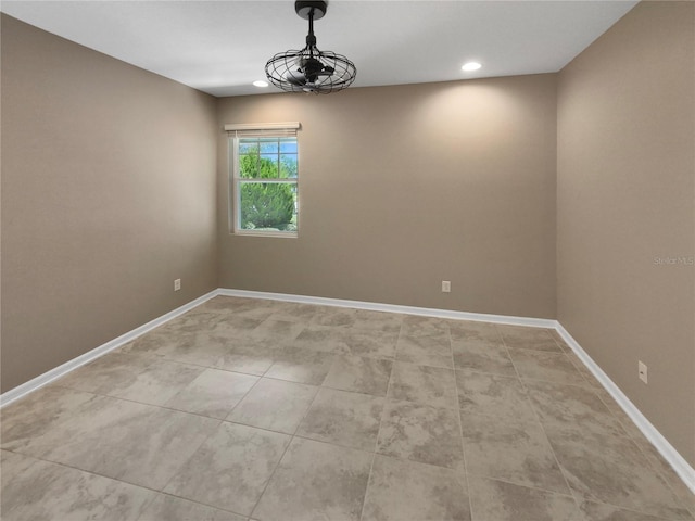 empty room with recessed lighting and baseboards