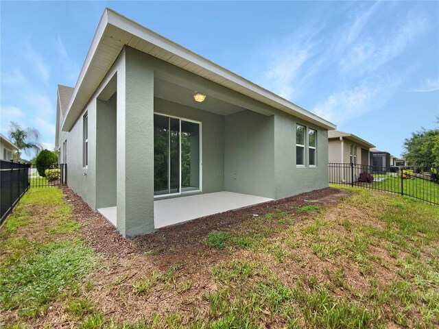 rear view of property with a patio area and a yard