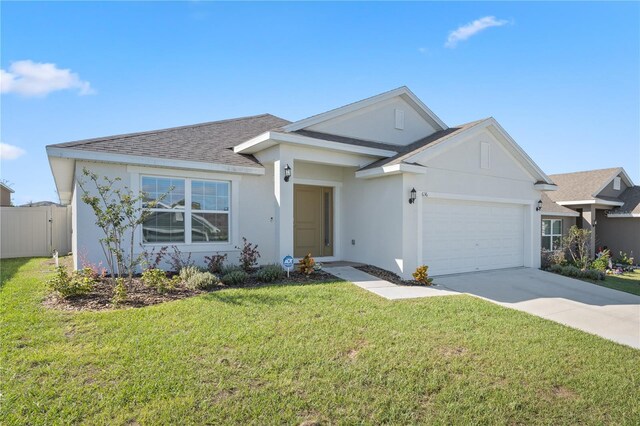 ranch-style home featuring a garage and a front yard