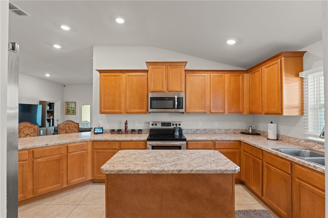 kitchen featuring light tile patterned flooring, sink, a kitchen island, stainless steel appliances, and lofted ceiling