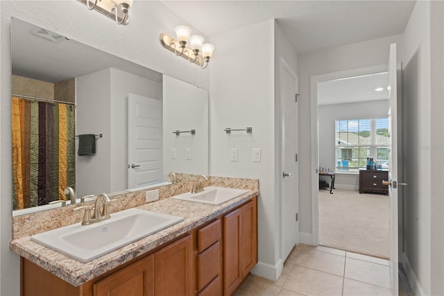 bathroom featuring dual bowl vanity and tile patterned floors