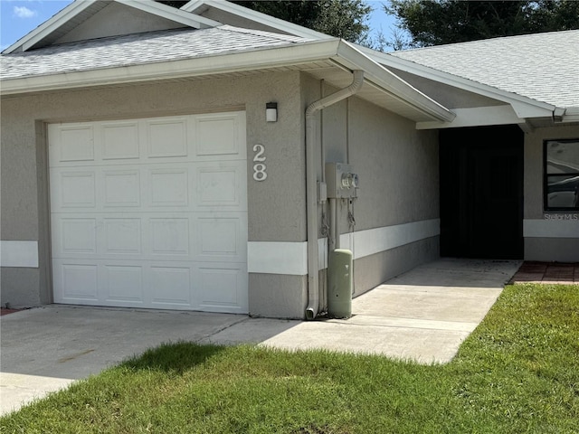 view of side of home featuring a garage and a yard