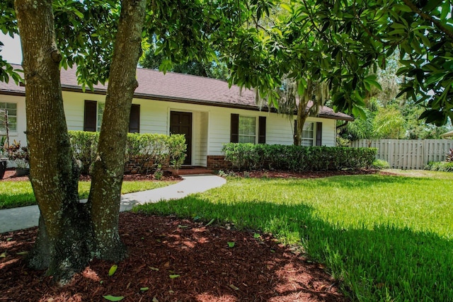 ranch-style house with a front lawn