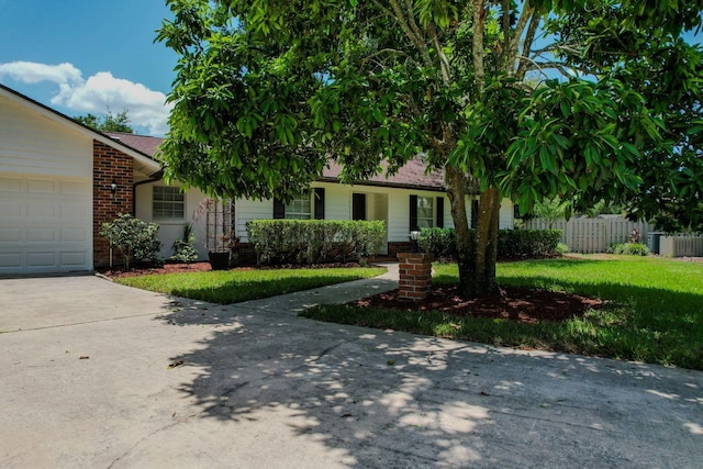 view of front of house with a front yard and a garage