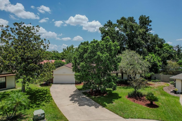 view of front of home featuring a garage and a front lawn