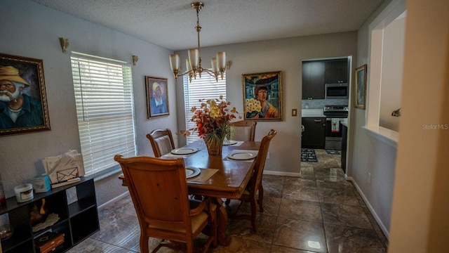 dining area featuring a textured ceiling and an inviting chandelier