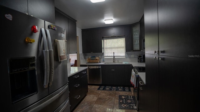 kitchen with backsplash, sink, and stainless steel appliances