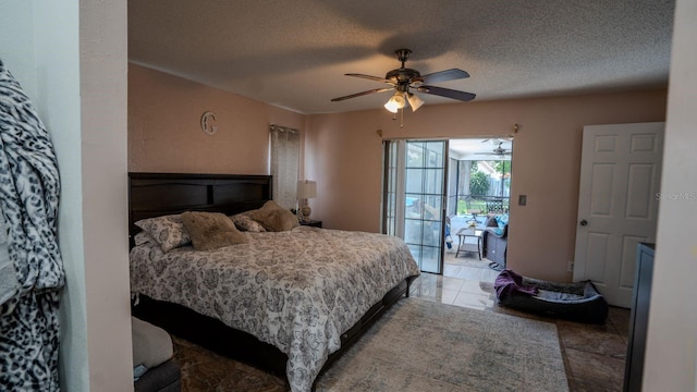 bedroom with access to exterior, a textured ceiling, and ceiling fan