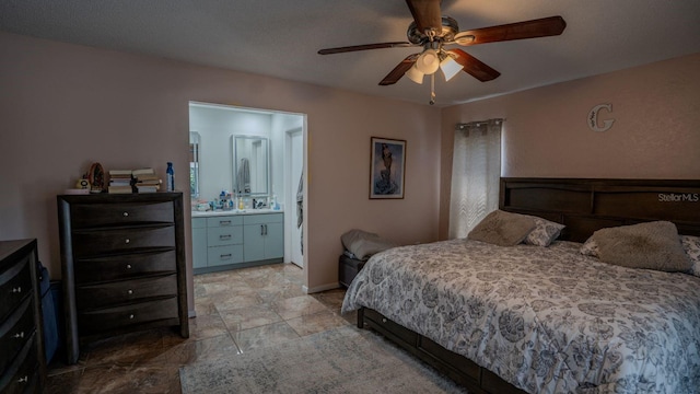 bedroom with ceiling fan and connected bathroom